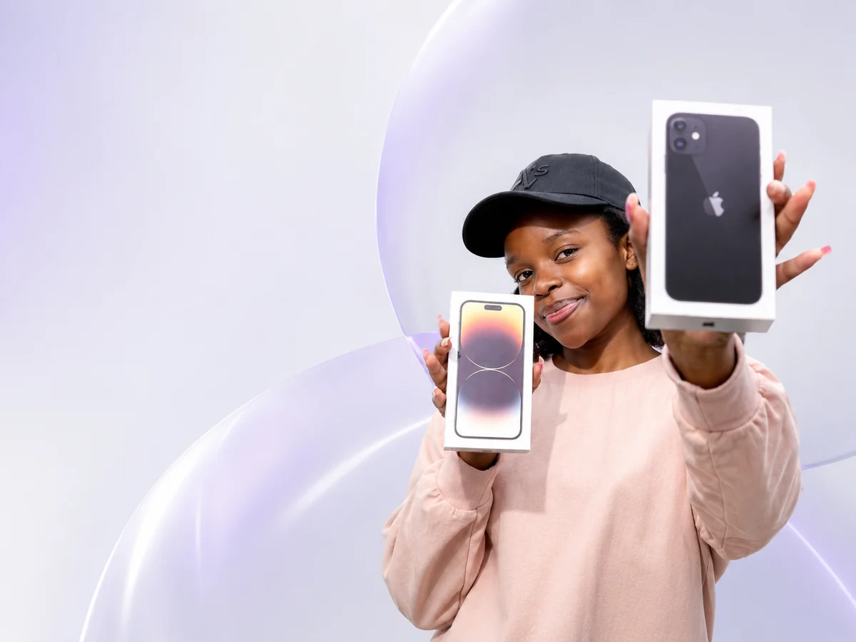Customer showing brand new boxed iPhones at ShaneMobilez